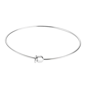 Detailed close-up of a minimalist polished stainless steel bangle with a spherical bead