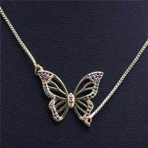 Golden butterfly necklace with colorful zircon wings and box chain on black leather