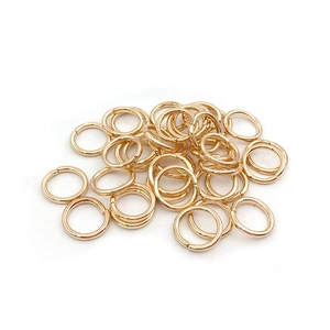 Bulk gold-plated jump rings for jewelry making and DIY crafts on a white background