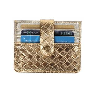 Close-up of golden woven card holder with multiple slots and metal snap fastener