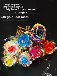 Close-up of colorful 24k gold foil artificial roses on a black marble surface