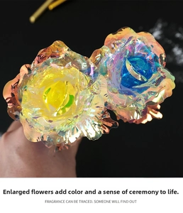 Detailed macro view of two iridescent 24k gold foil roses with vibrant blue and yellow centers