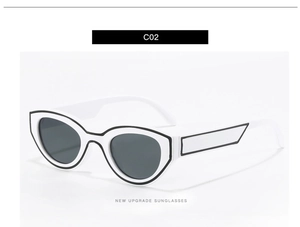 Detail view of white cat-eye sunglasses with bold black 2D pop art comic style outlines