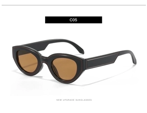 Detailed macro view of retro oval cat-eye sunglasses with striped temple design