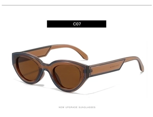 Close-up of vintage oval amber sunglasses with wide temples and high-gloss finish