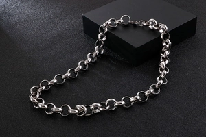 Detailed close-up of a silver stainless steel O-chain necklace on a black matte base
