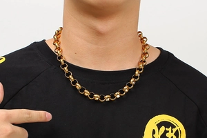 Close-up of a gold-plated stainless steel cable chain necklace on a female model
