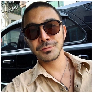 Retro oversized square tea-colored sunglasses for men and women on model in car setting