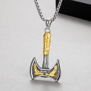 Close-up of Viking double axe pendant with gold eagle relief and silver finish