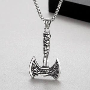 Detailed macro view of vintage Viking double-headed axe pendant with steel box chain