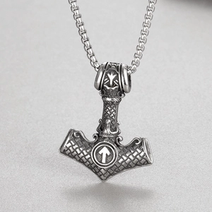 Macro shot of stainless steel Viking Mjölnir pendant with intricate totem engravings