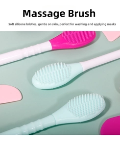 Detail of dual-head silicone facial mask brushes in pink, light blue and white colors