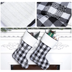 Detail of plaid Christmas stockings with white knit cuffs hanging on a festive fireplace