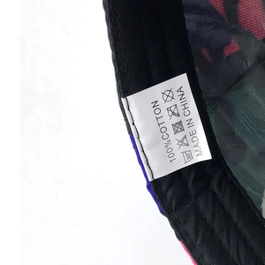Detail showing 100% cotton material label and inner stitching of the camo baseball cap