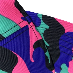 Close-up of camouflage baseball cap fabric with reinforced stitching and twill texture
