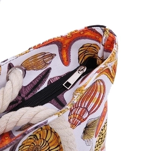 Women's beach tote bag with ocean seashell pattern, rope handles and zipper closure