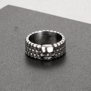 Macro detail of gothic skull ring showing brushed stainless steel texture and engraving