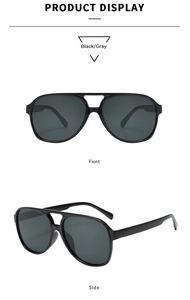 Detail view of black aviator sunglasses with a double-bridge frame and gray lenses