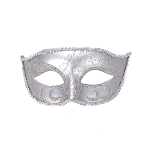 Detail of silver filigree masquerade mask with glitter edges and hollowed eye design
