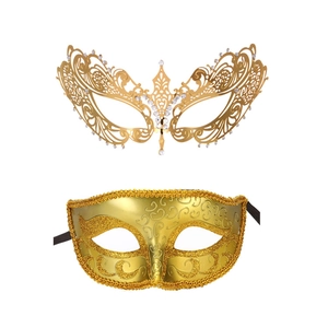 Detailed view of two gold masquerade masks with intricate cutout metal and rhinestone details
