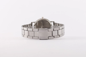 Detail of silver stainless steel watch strap and secure folding clasp on white background
