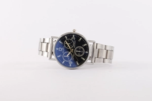 Detailed macro view of multi-functional blue gradient watch dial with silver steel band
