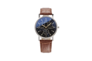 Macro detail of brown leather strap and navy blue dial on a quartz men's watch