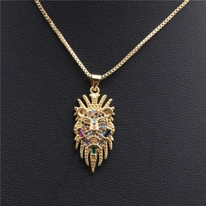 Golden lion head pendant necklace with colorful cubic zirconia on black leather background
