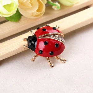 Sparkling ladybug brooch with red enamel and crystals on elegant gold-plated alloy