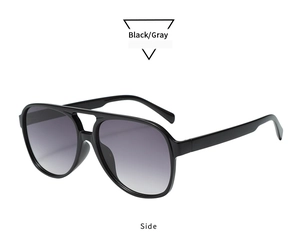 Side view of vintage double-bridge aviator sunglasses with black frames and gray lenses
