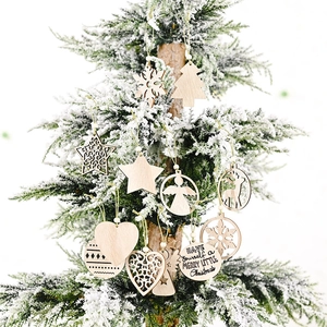 Rustic natural wood Christmas ornaments set hanging on a snow-decorated festive tree branch