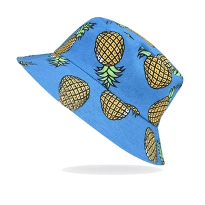 Detail of blue canvas bucket hat featuring hand-painted yellow pineapple patterns