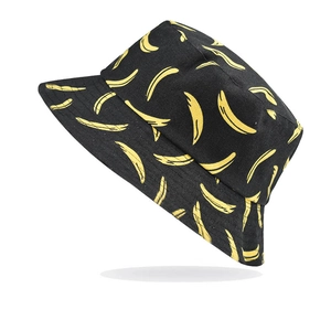 Detailed view of black bucket hat with yellow banana pattern made of durable canvas material