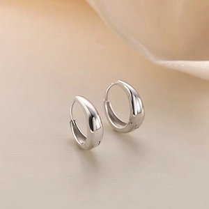 Pair of minimalist silver-colored teardrop earrings with high-gloss mirror finish surface