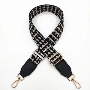 Adjustable wide shoulder strap with black houndstooth pattern and gold metal hooks