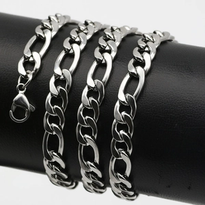 Silver Figaro chain necklace in stainless steel with lobster clasp on display stand