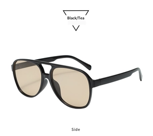Side view of retro black double-bridge oval sunglasses with brown tinted lenses