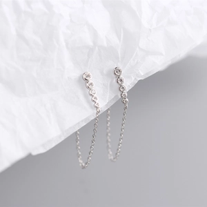 Macro shot of S925 sterling silver drop earrings with five aligned zircons and chain
