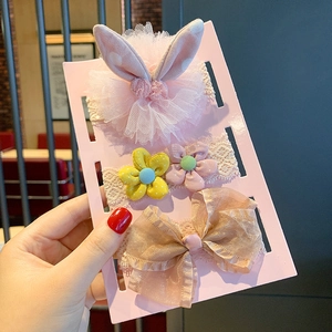 Detailed view of three baby headbands with mesh flowers and bows on lace bands