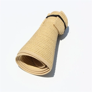 Detail of rollable straw sun hat with elastic strap for easy travel storage