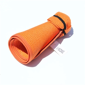 Detail showing the portable roll-up design and woven texture of the orange straw sun hat