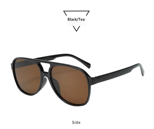 Side view of retro pilot oval sunglasses with black frames and tea lenses