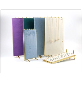 Detailed view of luxury velvet jewelry display boards with golden metal bead trimming