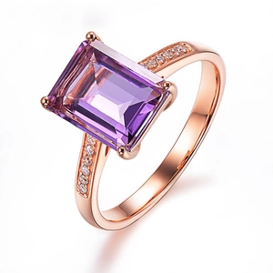 Macro shot of rectangular purple amethyst ring with rose gold band and side diamonds