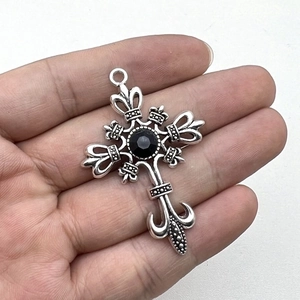Vintage Gothic Punk Silver Cross Pendant with Black Gemstone center held in hand