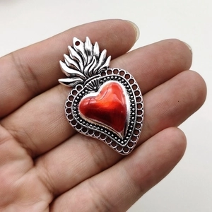 Gothic style flaming heart pendant with red center and vintage silver alloy details