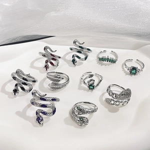 Silver snake rings set with colorful zircon stones in a vintage minimalist aesthetic
