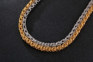 Close-up of gold and silver crown braided chains with intricate metal textures