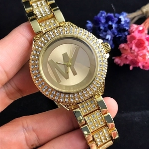 Gold fashion watch for women with dual-row crystal bezel and MK logo dial