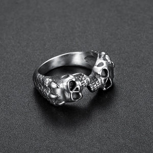 Vintage stainless steel ring featuring dual skull heads and dragon claw scale patterns